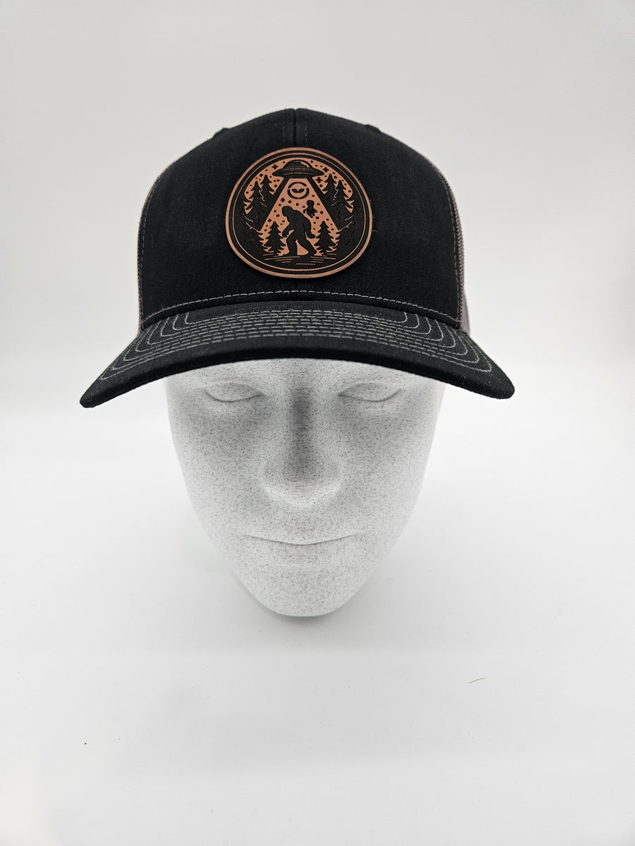 Black trucker hat with a Bigfoot UFO patch