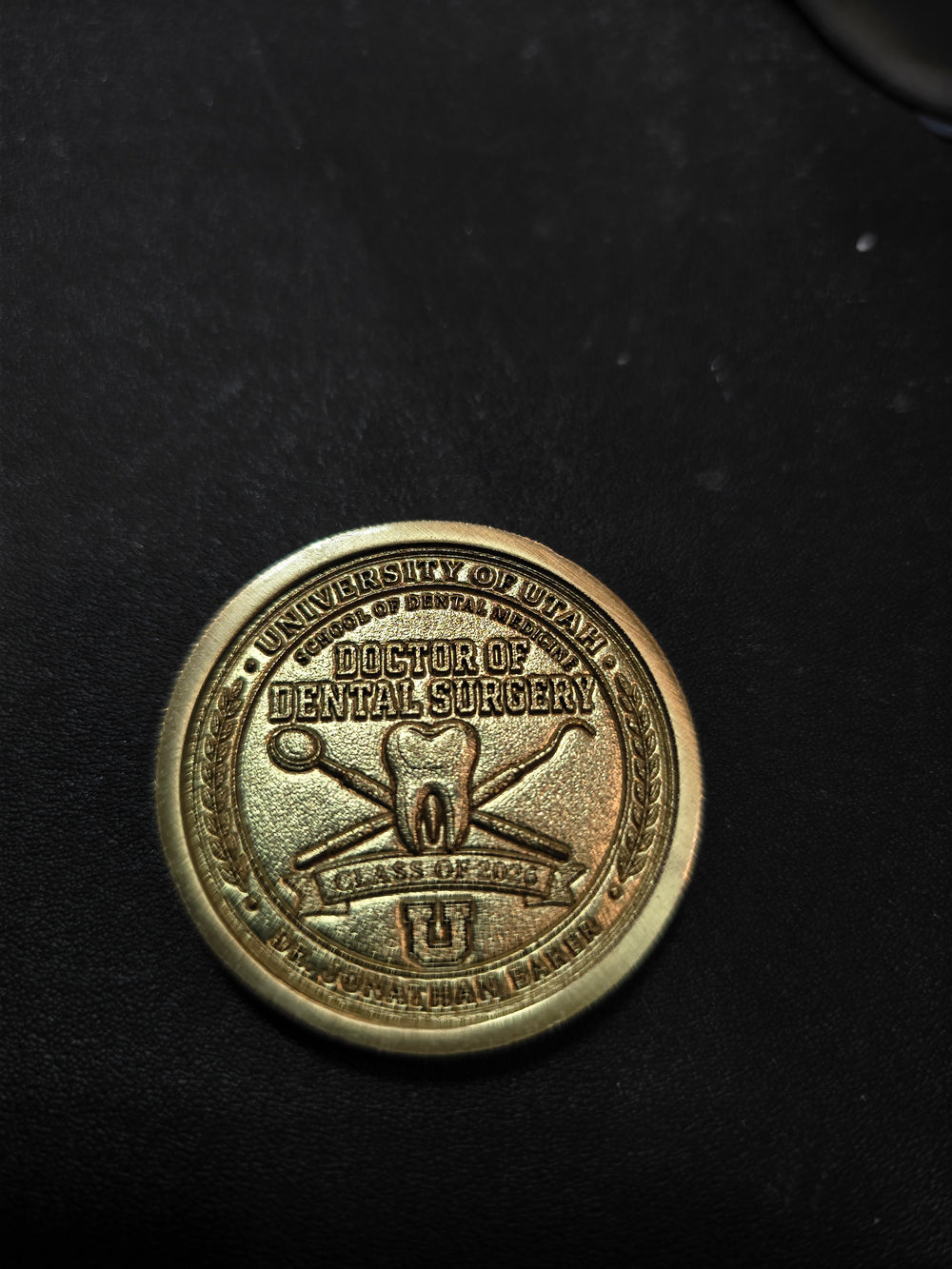 Embossed brass graduation coin