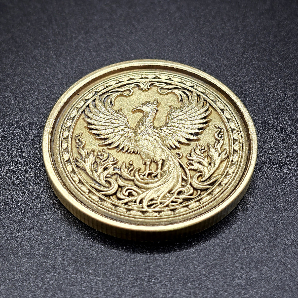 Phoenix brass coin, angled view